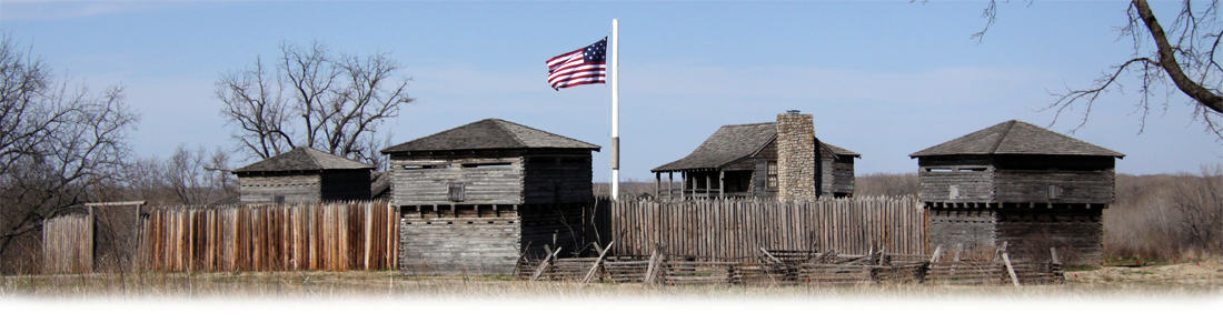 Wooden fort with American flag flying beside it