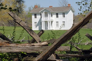 White two-story house in a field