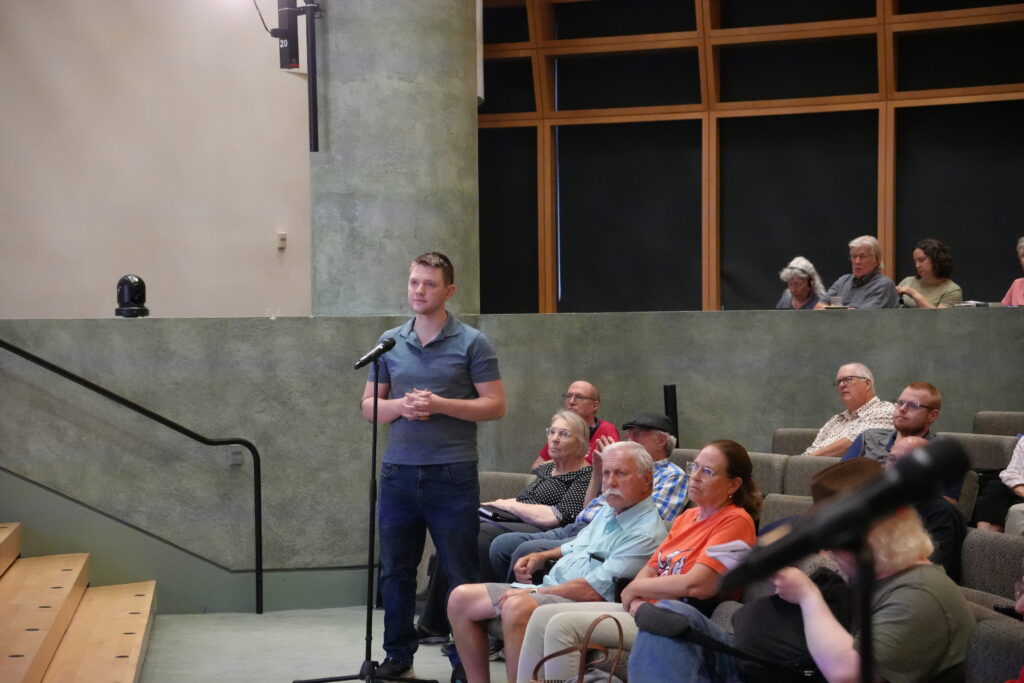 Person stands at microphone