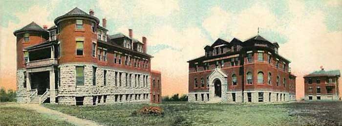 Ward Hall on the left and Stanley Hall on the right on Western University's campus. Both are brick structures with a limestone skirt.