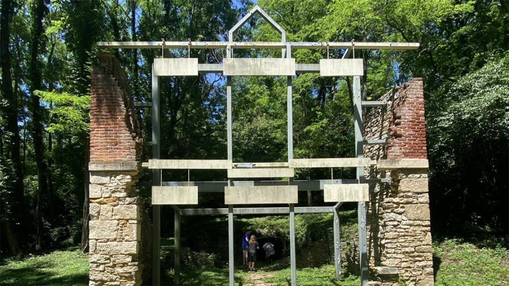 Ruins of the Quindaro Brewery. Two slumping brick walls are bolstered by metal frames that attempt to recreate what the brewery would have looked like,