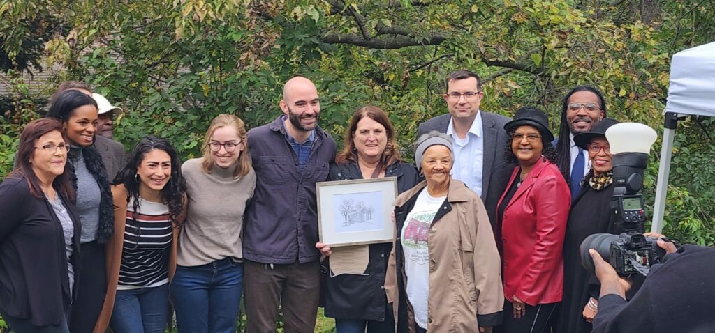 Group of people holding an award and having their photo taken