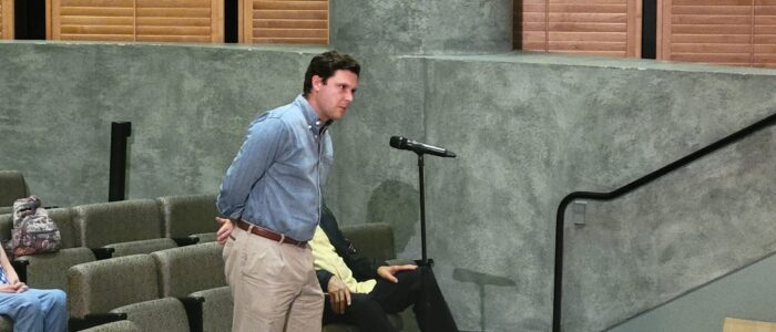 Man stands at microphone
