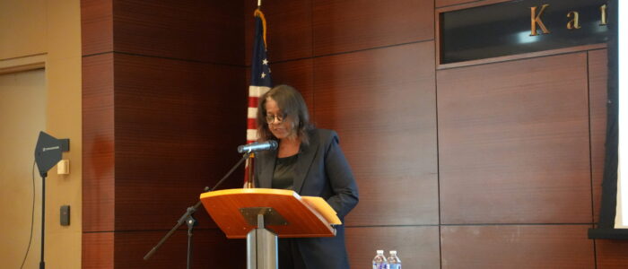 Woman stands at podium