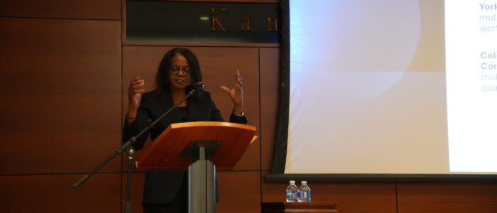 Woman stands at podium